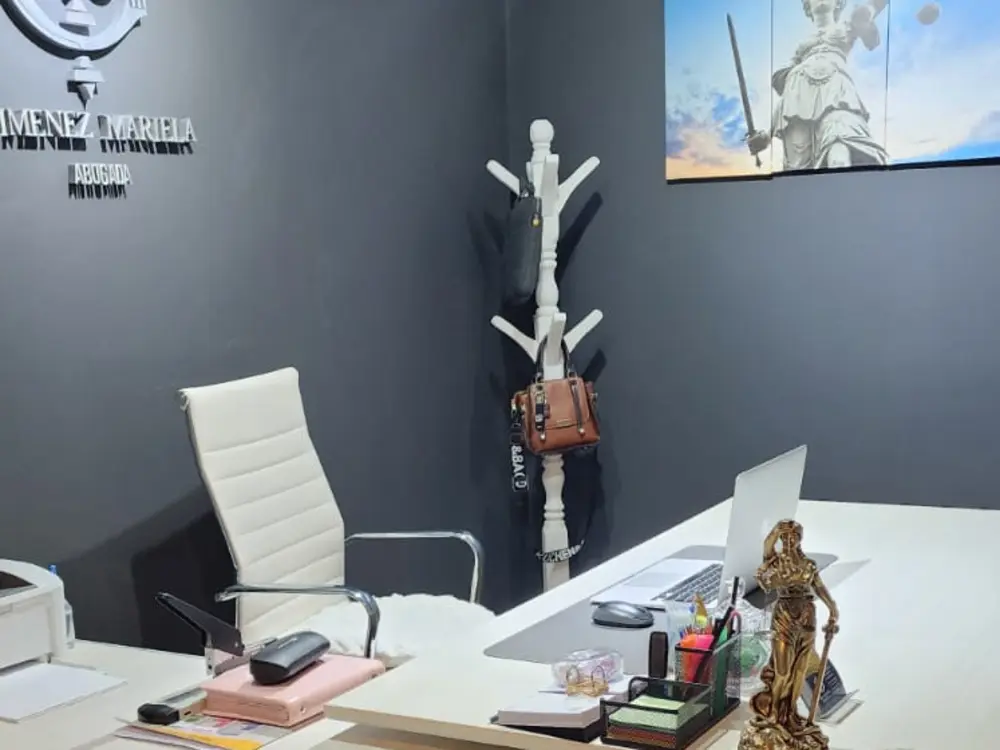 Escritorio del estudio con el isotipo de la Dra. Gimenez en la pared